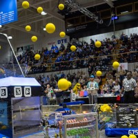 Audience members watch yellow balls fly through the air during the 2026 GVSU West MI District Event